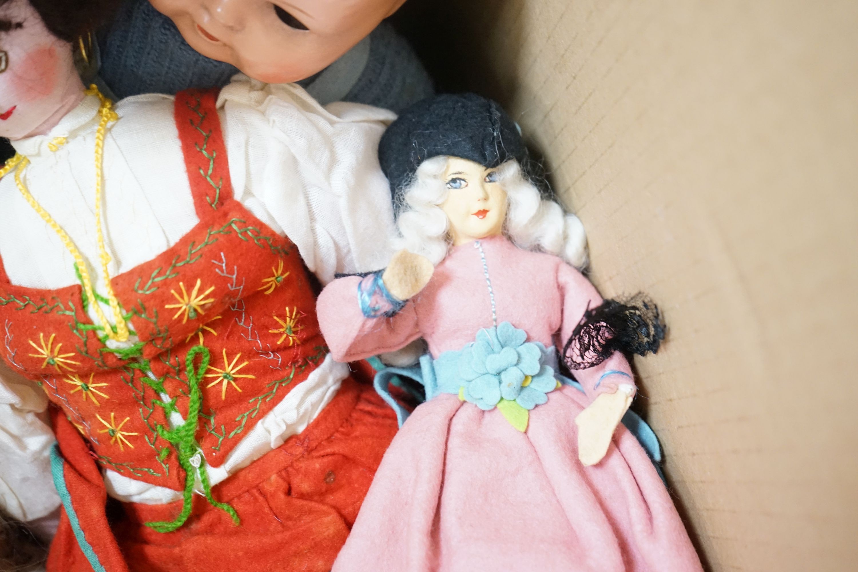 A collection of dolls and two soft toys